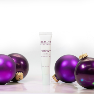 Alchimie Forever Rejuvenative Eye Balm with purple ornaments on a white background