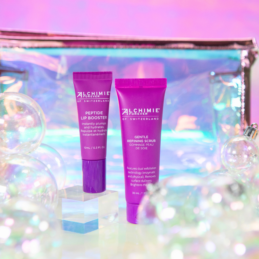 Two purple Alchimie Forever skincare tubes on a glittery background