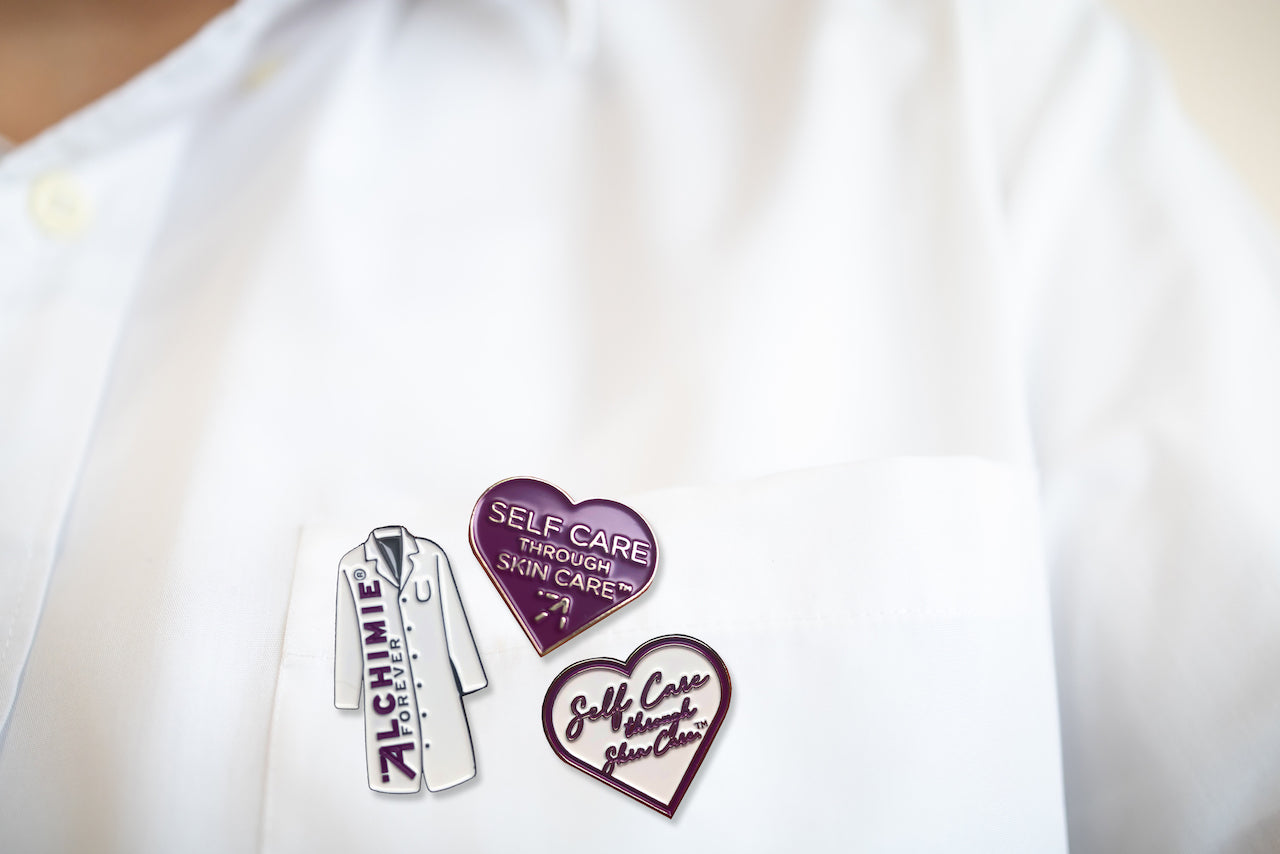 Our brand new white Alchimie Forever lab coat pin.